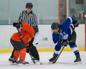 Two players gearing up for a puck drop at a Chicago Hockey League game